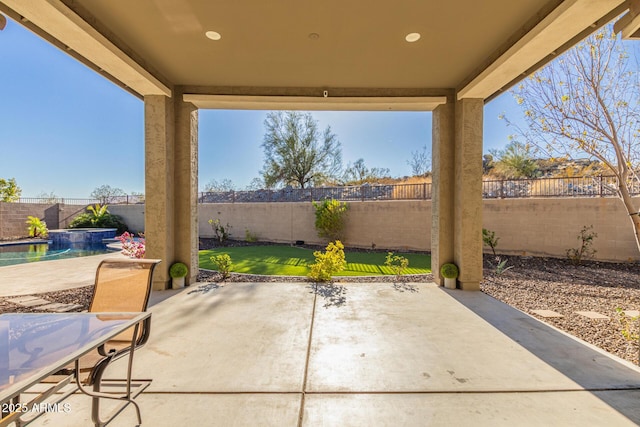 view of patio / terrace with a fenced in pool