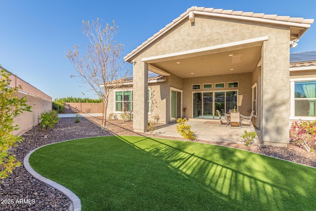 rear view of property with a patio area and a lawn