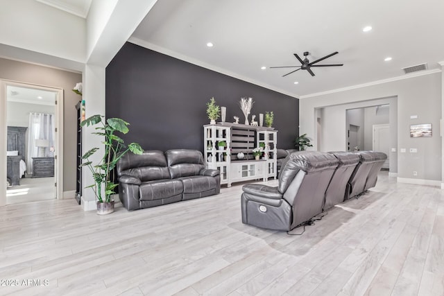 living room with crown molding, ceiling fan, and light hardwood / wood-style floors