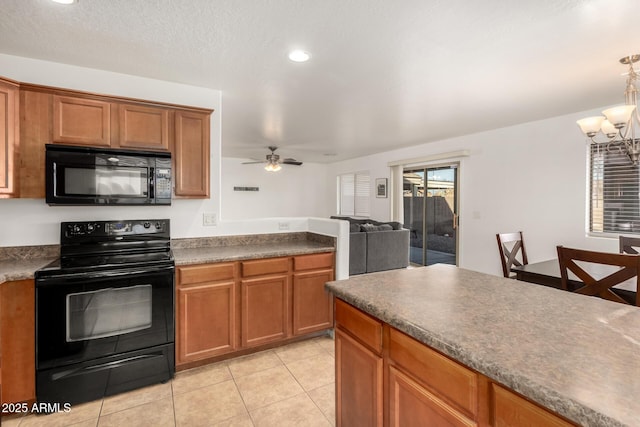 kitchen featuring ceiling fan with notable chandelier, pendant lighting, light tile patterned floors, and black appliances