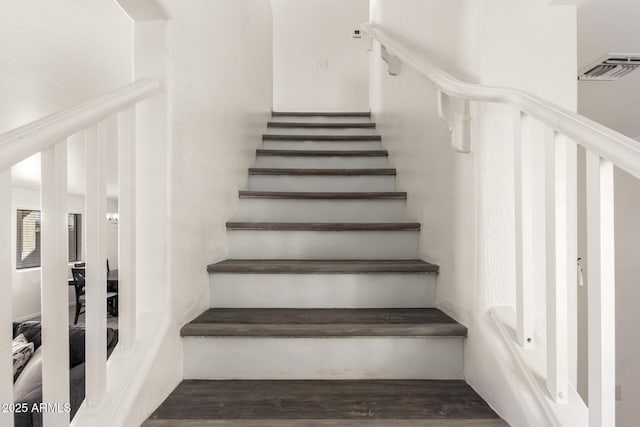 stairs featuring hardwood / wood-style floors