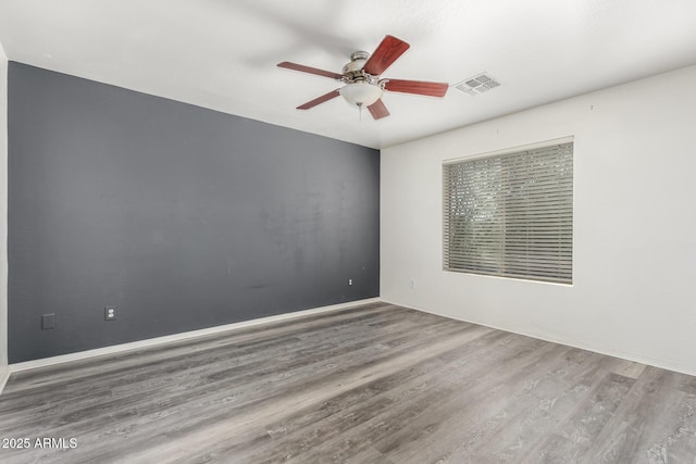 unfurnished room featuring hardwood / wood-style floors and ceiling fan