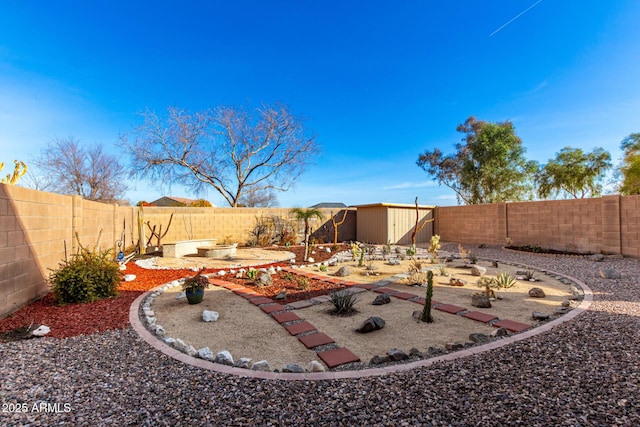 view of yard with a storage shed and a patio