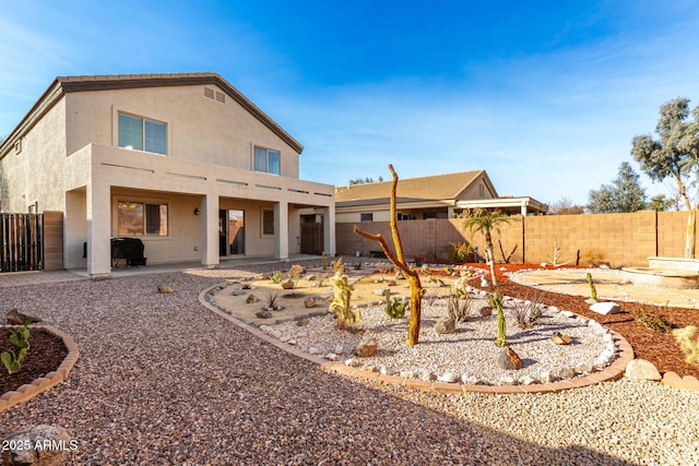 back of house with a patio area