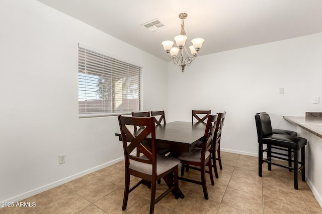 tiled dining room with a notable chandelier