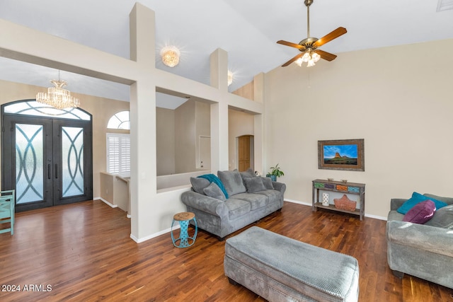 living room featuring dark hardwood / wood-style flooring, french doors, high vaulted ceiling, and ceiling fan with notable chandelier