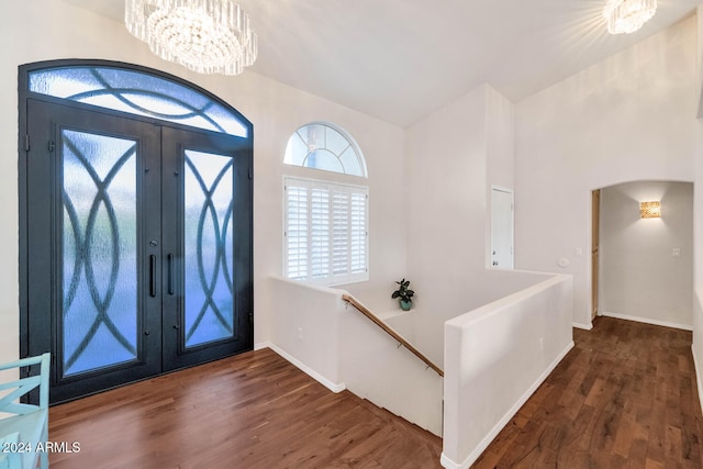 entrance foyer featuring a healthy amount of sunlight, french doors, and dark wood-type flooring