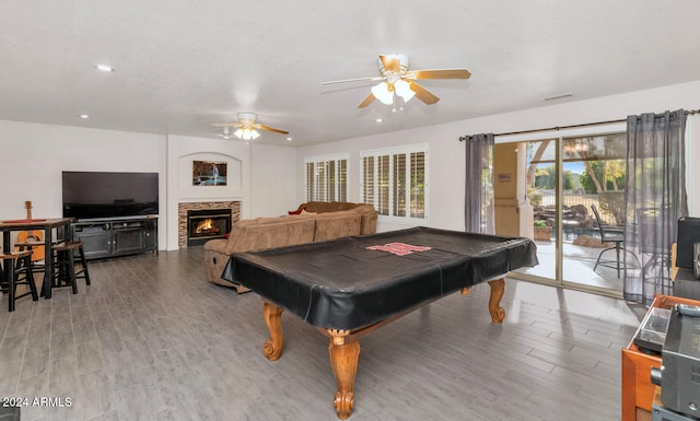 game room featuring ceiling fan, a fireplace, light hardwood / wood-style floors, and billiards