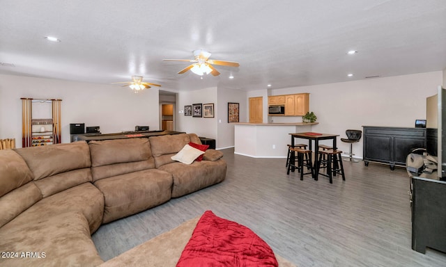 living room featuring wood-type flooring and a textured ceiling