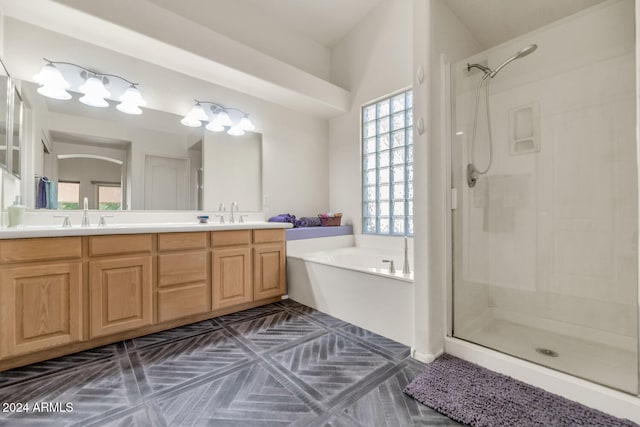 bathroom with vanity and independent shower and bath