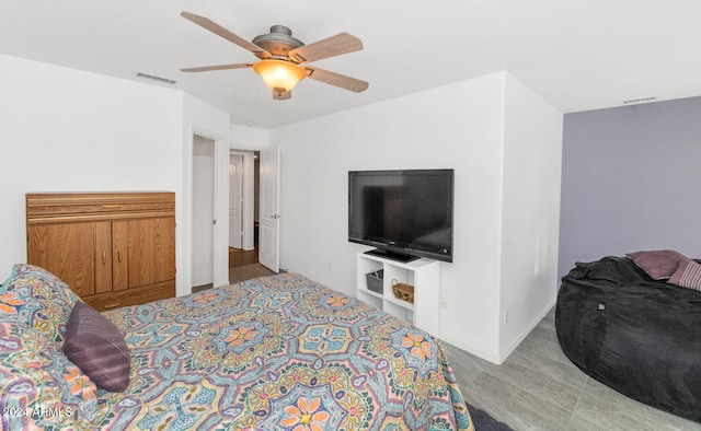 bedroom with ceiling fan and light hardwood / wood-style floors