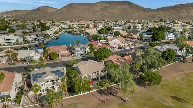 birds eye view of property with a water and mountain view