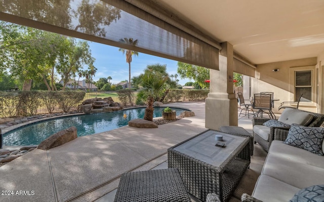 view of patio with an outdoor living space and a fenced in pool