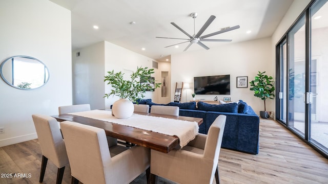 dining room with ceiling fan and light hardwood / wood-style flooring