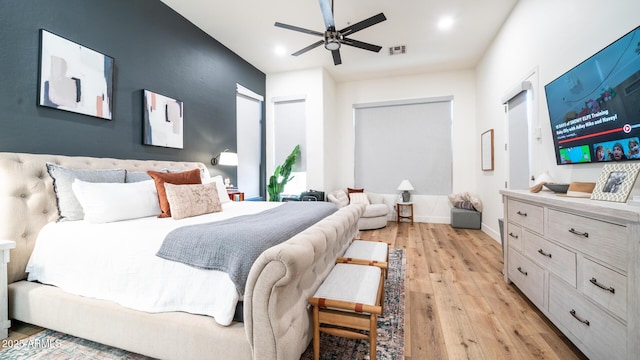 bedroom with ceiling fan and light wood-type flooring