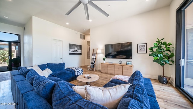 living room with ceiling fan and light wood-type flooring