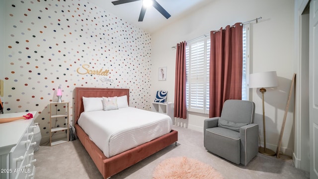 carpeted bedroom with vaulted ceiling and ceiling fan