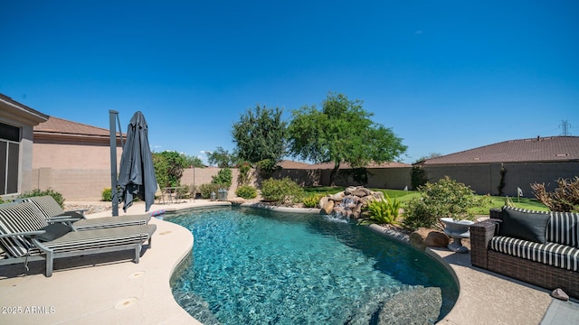 view of swimming pool with a patio and pool water feature