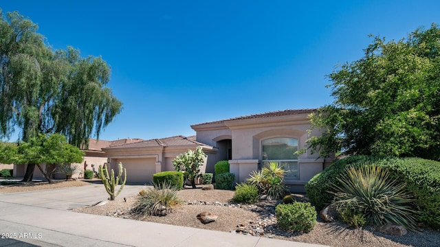 mediterranean / spanish-style house with a garage