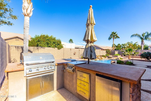 view of patio / terrace with a fenced in pool and area for grilling