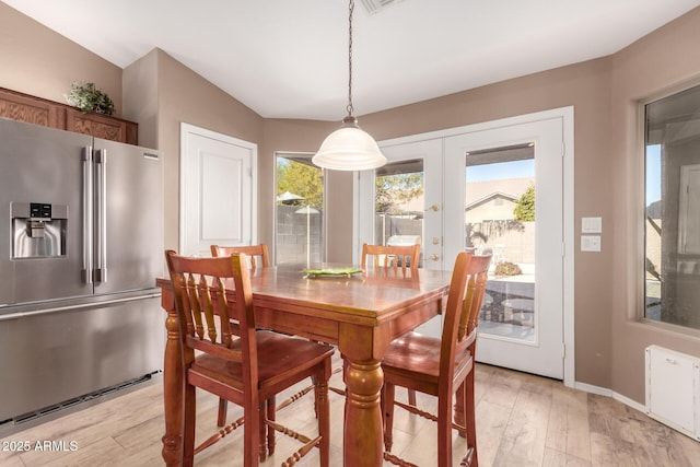 dining room featuring french doors and light hardwood / wood-style floors