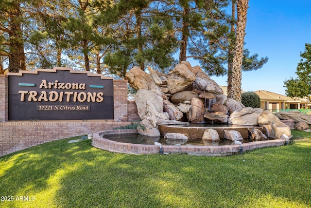 community sign featuring a yard