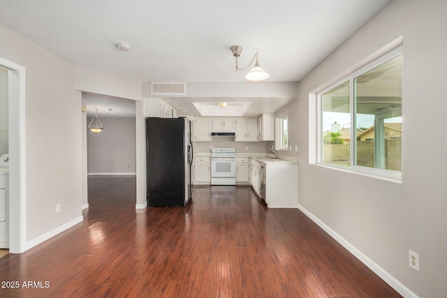 kitchen with stainless steel fridge, electric stove, baseboards, a sink, and white cabinetry