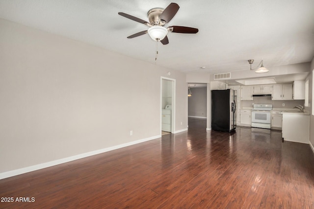 unfurnished living room with washer / dryer, ceiling fan, a sink, baseboards, and dark wood-style flooring
