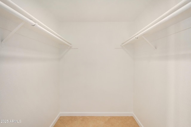 walk in closet featuring light tile patterned flooring