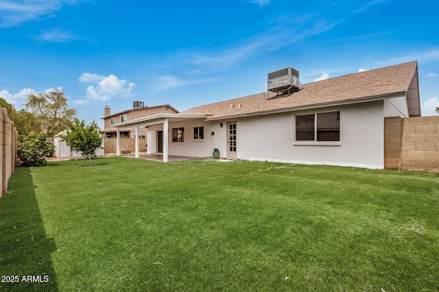 rear view of property featuring cooling unit, a patio area, and a shingled roof