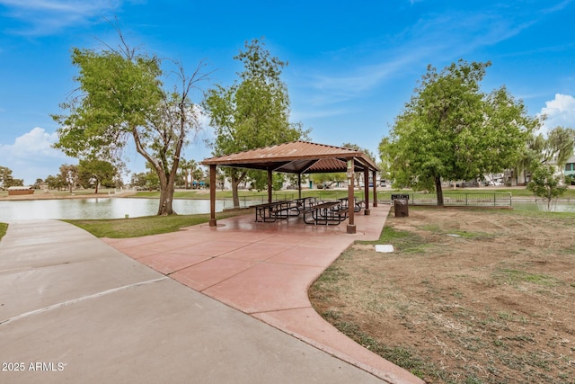 surrounding community with a gazebo and a water view