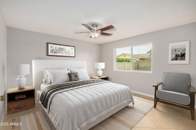 bedroom with light tile patterned floors, baseboards, and ceiling fan