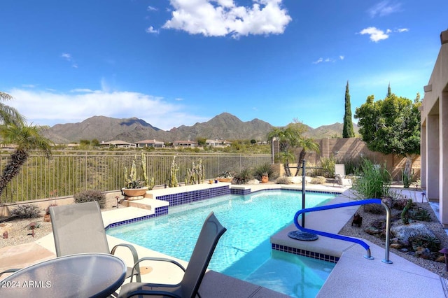 view of swimming pool featuring a mountain view and a patio area