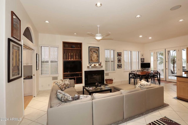 tiled living room with ceiling fan