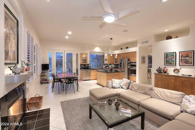 tiled living room featuring ceiling fan