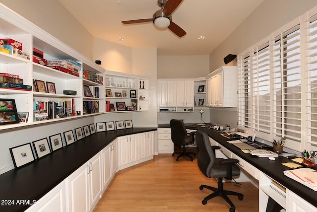 office area with ceiling fan, built in desk, and light wood-type flooring