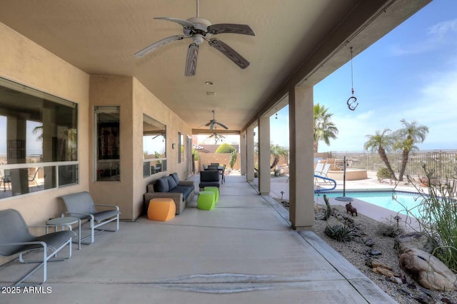 view of patio / terrace with a fenced in pool and ceiling fan