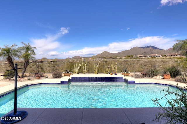 view of swimming pool with a mountain view