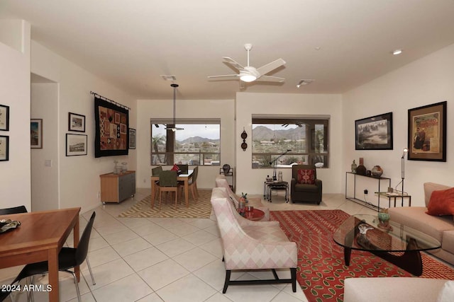 living room featuring light tile patterned floors and ceiling fan