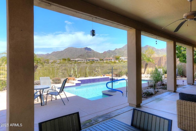 view of pool featuring a mountain view, a patio, and ceiling fan