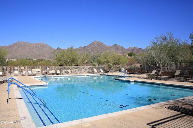 view of pool with a mountain view and a patio