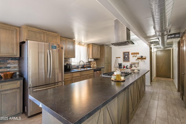 kitchen with island exhaust hood, dark countertops, appliances with stainless steel finishes, a kitchen island, and a sink