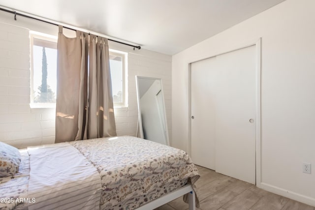 bedroom featuring light wood-style floors and a closet