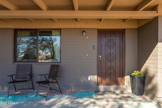 property entrance featuring brick siding