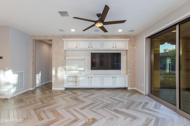 unfurnished living room with ceiling fan and light parquet flooring