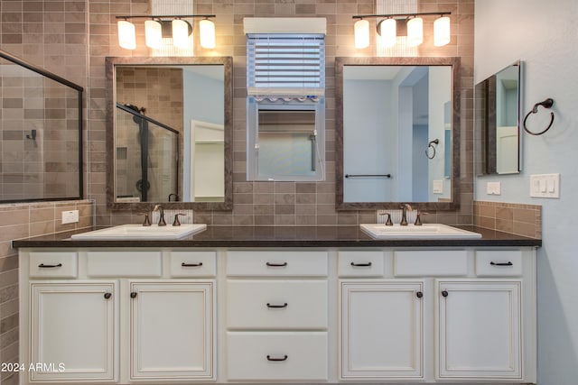 bathroom with decorative backsplash, vanity, and walk in shower