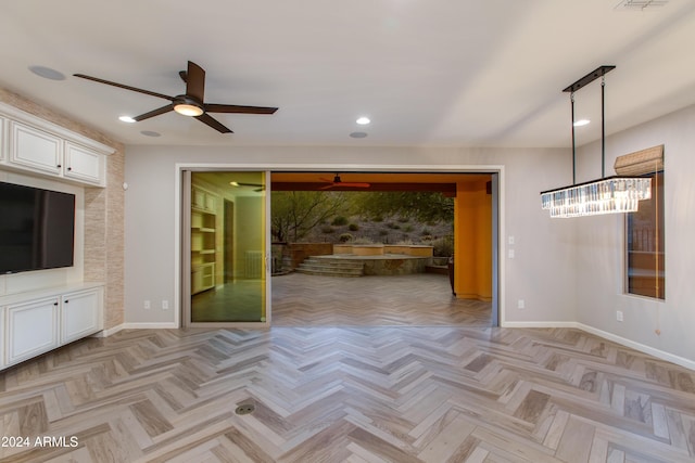 unfurnished living room with ceiling fan and light parquet floors