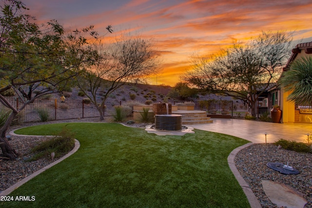 yard at dusk with a patio