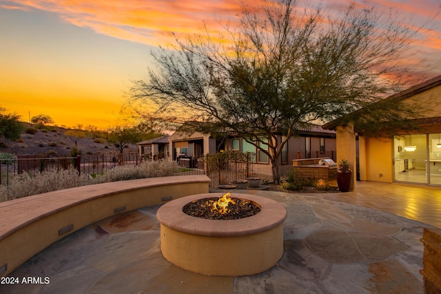 view of property's community with a patio area and an outdoor fire pit