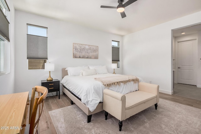 bedroom with baseboards, a ceiling fan, and wood finished floors